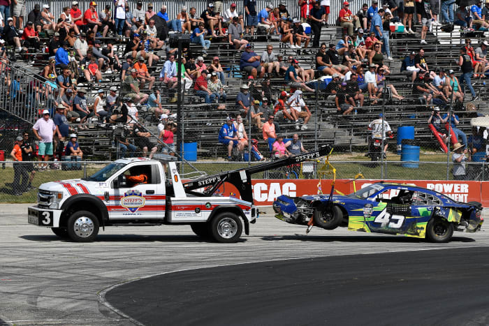 Sage Karam's vehicle gets towed off the track on Saturday.