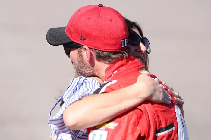 Kelley Earnhardt hugs her brother, Dale Earnhardt Jr., on the track at a NASCAR event.