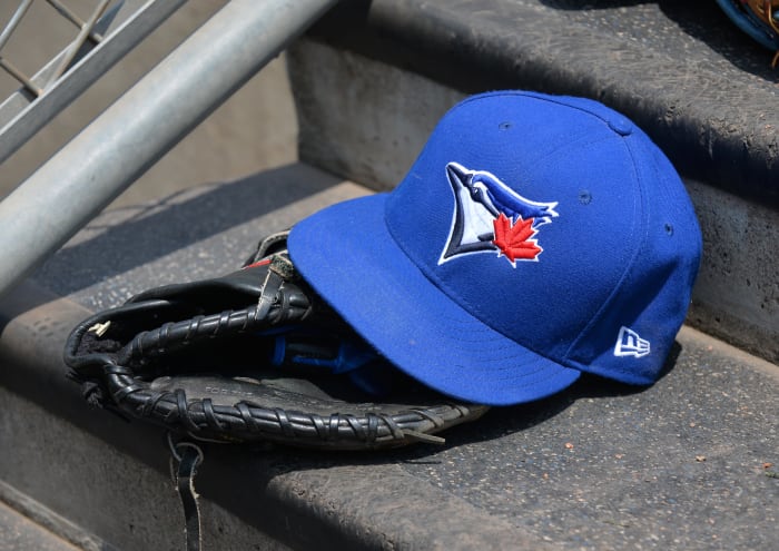 DETROIT, MI - JULY 16: A detailed view of a Toronto Blue Jays baseball hat and glove sitting on the dugout steps during the game against the Detroit Tigers at Comerica Park on July 16, 2017 in Detroit, Michigan.  The Tigers defeated the Blue Jays 6-5.  (Photo by Mark Cunningham/MLB Photos via Getty Images)