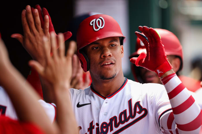 WASHINGTON, DC - JULY 13: Juan Soto #22 of the Washington Nationals celebrates with teammates after hitting a three run home run against the Seattle Mariners during the ninth inning of game one of a doubleheader at Nationals Park on July 13, 2022 in Washington, DC. (Photo by Scott Taetsch/Getty Images)
