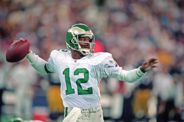 Former NFL great Randall Cunningham throws a ball down the field.
