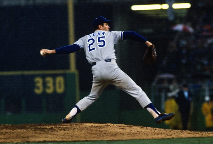PHILADELPHIA, PA - CIRCA 1974: Pitcher Tommy John #25 of the Los Angeles Dodgers pitches against the Philadelphia Phillies during an Major League Baseball game circa 1974 at Veterans Stadium in Philadelphia, Pennsylvania. John played for the Dodgers from 1972-74 and 1976-78. (Photo by Focus on Sport/Getty Images)