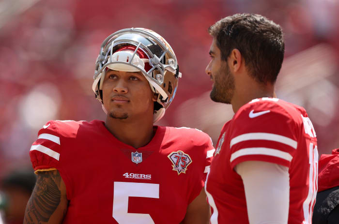 SANTA CLARA, CALIFORNIA - AUGUST 29: Jimmy Garoppolo #10 and Trey Lance #5 of the San Francisco 49ers talk to each other on the sidelines before their preseason game against the Las Vegas Raiders at Levi's Stadium on August 29, 2021 in Santa Clara, California. (Photo by Ezra Shaw/Getty Images)