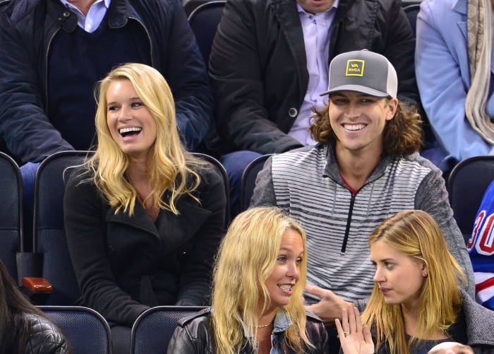 Jacob deGrom and his wife in the stands at a New York Rangers game.