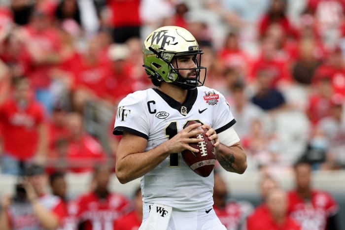 JACKSONVILLE, FLORIDA - DECEMBER 31: Sam Hartman #10 of the Wake Forest Demon Deacons looks to pass against the Rutgers Scarlet Knights during the TaxSlayer Gator Bowl at TIAA Bank Field on December 31, 2021 in Jacksonville, Florida. (Photo by Sam Greenwood/Getty Images)