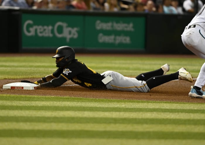 PHOENIX, ARIZONA - AUGUST 09: Rodolfo Castro #14 of the Pittsburgh Pirates slides into third base as his cell phone falls out of his pocket during the fourth inning of a game against the Arizona Diamondbacks at Chase Field on August 09, 2022 in Phoenix, Arizona.  (Photo by Norm Hall/Getty Images)