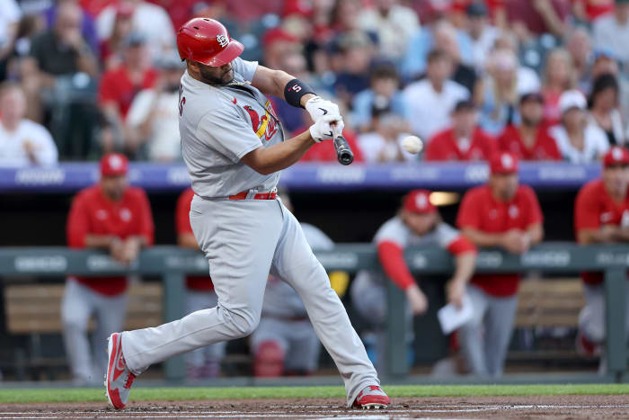 Albert Pujols hits an RBI single against the Colorado Rockies.