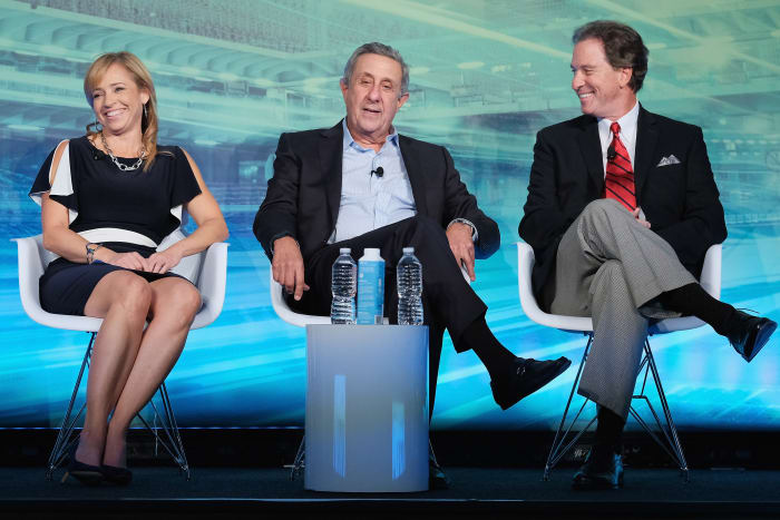 A photo of Stephania Bell, Len Berman and Kevin Harlan on stage at an event.