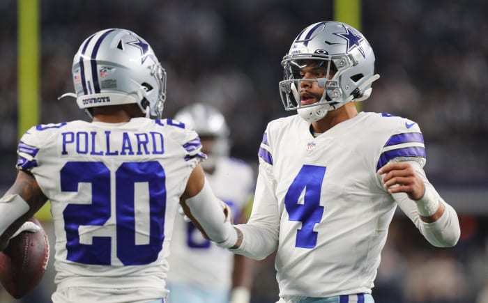 Dak Prescott with Tony Pollard on the field for the Dallas Cowboys.