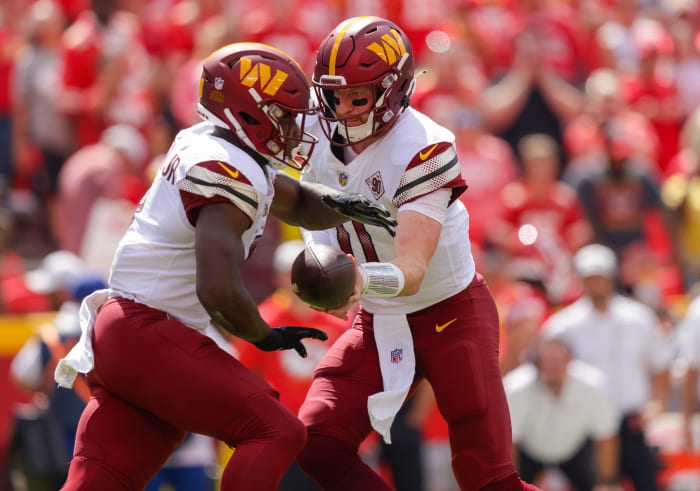 Carson Wentz hands off to Washington Commanders rookie running back Brian Robinson.