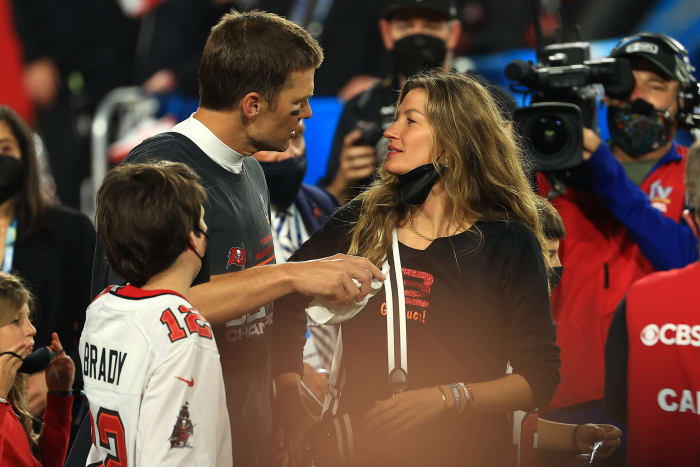 Gisele Bundchen sees husband Tom Brady on the field after the Super Bowl.