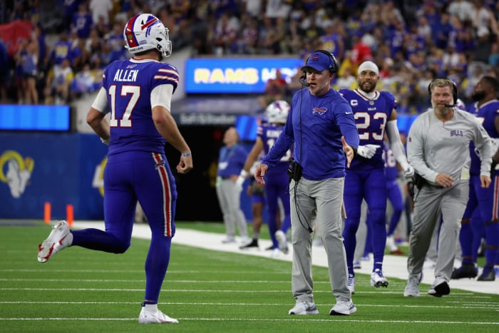 Josh Allen high-fives Sean McDermott on the Bills sideline.