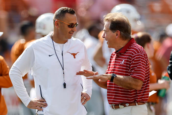 Steve Sarkisian talking with Nick Saban before kickoff.