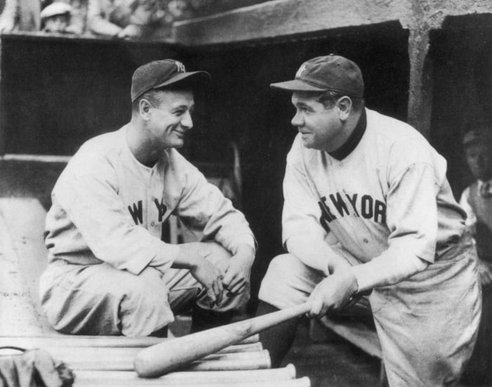 Babe Ruth talking to Lou Gehrig.