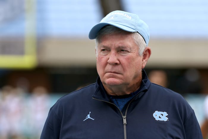 Mack Brown of the North Carolina Tar Heels watches his team warm up.