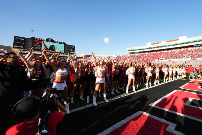 Texas Tech fans and cheerleaders on the field following the game on Saturday.