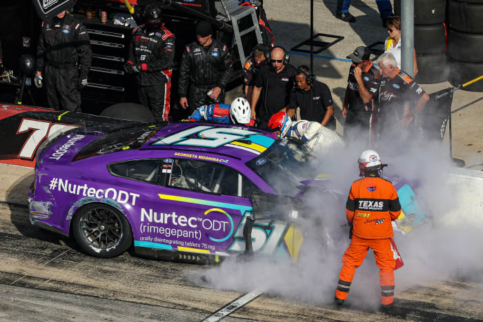 FORT WORTH, TEXAS - SEPTEMBER 25: The NASCAR Safety Crew assist Cody Ware, driver of the #51 Nurtec ODT Ford, after spinning into the pit area during the NASCAR Cup Series Auto Trader EchoPark Automotive 500 at Texas Motor Speedway on September 25, 2022 in Fort Worth, Texas. (Photo by James Gilbert/Getty Images)