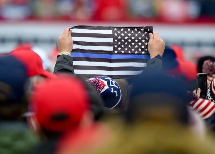 Bern twp., PA - October 31: A supporter of President Donald J. Trump holds a Thin Blue Line American flag, with the stars and all the stripes but one blue one, black and white, to show their support for law enforcement. At the Reading Regional Airport in Bern Township, PA Saturday afternoon October 31, 2020 where United States President Donald J. Trump spoke during a campaign rally for his bid for reelection. (Photo by Ben Hasty/MediaNews Group/Reading Eagle via Getty Images)