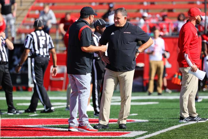 Ryan Day and Greg Schiano chat at midfield before a game.