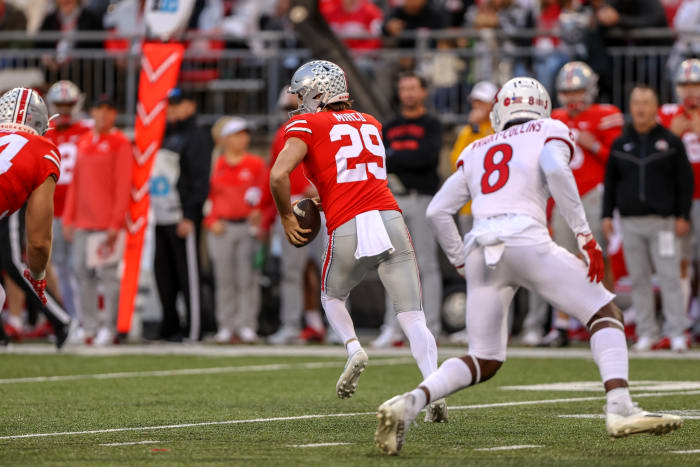 Ohio State punter Jesse Mirco takes off on a fake punt against Rutgers.