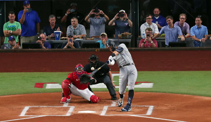 ARLINGTON, TX - OCTOBER 4: Aaron Judge #99 of the New York Yankees hits his 62nd home run of the season against the Texas Rangers during the first inning in game two of a double header at Globe Life Field on October 4, 2022 in Arlington , Texas.  Judge has now set the American League record for home runs in a single season.  (Photo by Ron Jenkins/Getty Images)