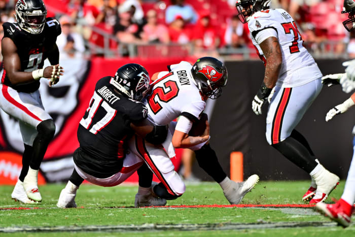 Bucs quarterback Tom Brady hit with a roughing the passer penalty.