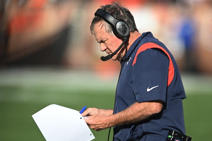 Bill Belichick looks at his playsheet during a game.