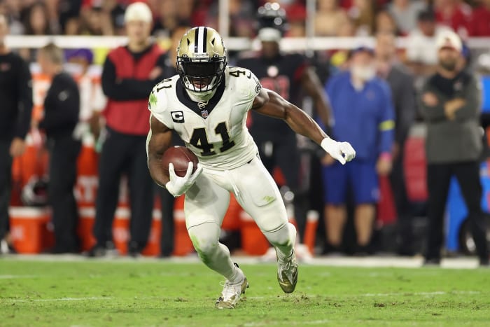 Alvin Kamara runs with the football for the Saints.