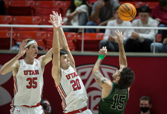 Manhattan's Jose Perez goes up for a shot over two Utah players.