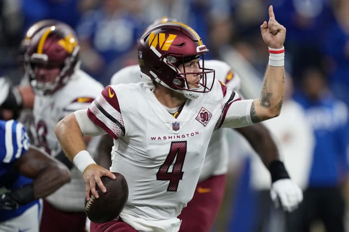Taylor Heinicke of the Washington Commanders scrambles against the Indianapolis Colts.