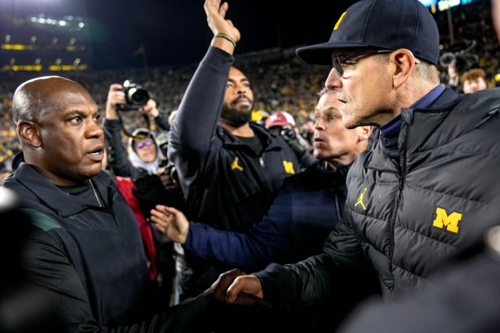 Michigan coach Jim Harbaugh and Michigan State coach Mel Tucker.