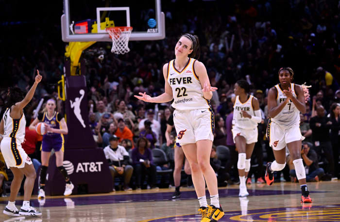 Caitlin Clark shrugs after making 3-pointer.