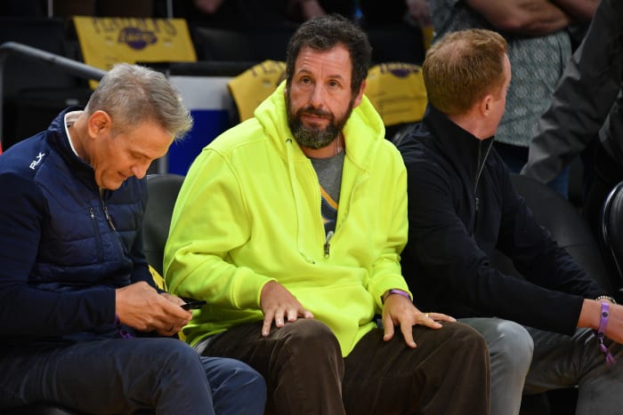 Adam Sandler sits courtside at a Lakers game.