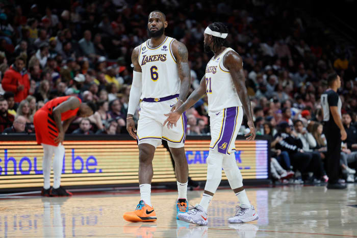 Los Angeles Lakers small forward LeBron James (6) and point guard Patrick Beverley (21) talk during the second half against the Portland Trail Blazers at Moda Center.