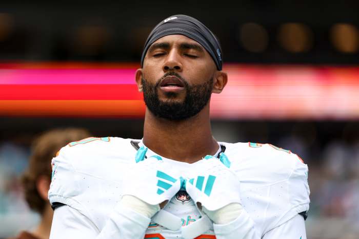 MIAMI GARDENS, FL - NOVEMBER 19: Justin Bethel #20 of the Miami Dolphins stands on the sidelines during the national anthem prior to an NFL football game against the Las Vegas Raiders at Hard Rock Stadium on November 19, 2023 in Miami Gardens, Florida. (Photo by Kevin Sabitus/Getty Images)