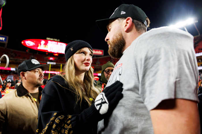 Travis Kelce with Taylor Swift on the field.