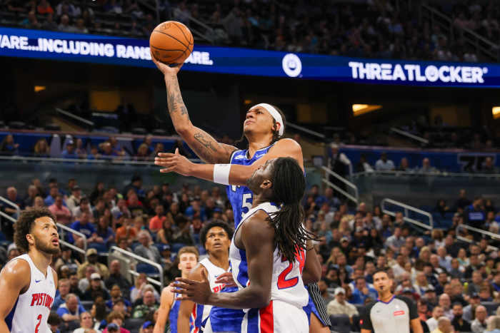 Orlando Magic forward Paolo Banchero (5) is fouled by Detroit Pistons center Isaiah Stewart (28) during the first quarter at KIA Center. Mandatory Credit: Mike Watters-Imagn Images