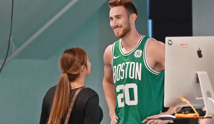 BOSTON, MA - SEPTEMBER 13: Boston Celtics' Gordon Hayward smiles in uniform with his wife Robyn, left, during a photo shoot after meeting with the media at the team's practice facility in the Brighton neighborhood of Boston to give an update on his condition as he comes back from the left ankle/foot injury he suffered during last season's opening game in Cleveland on Sep.  13, 2018. (Photo by Jim Davis/The Boston Globe via Getty Images)