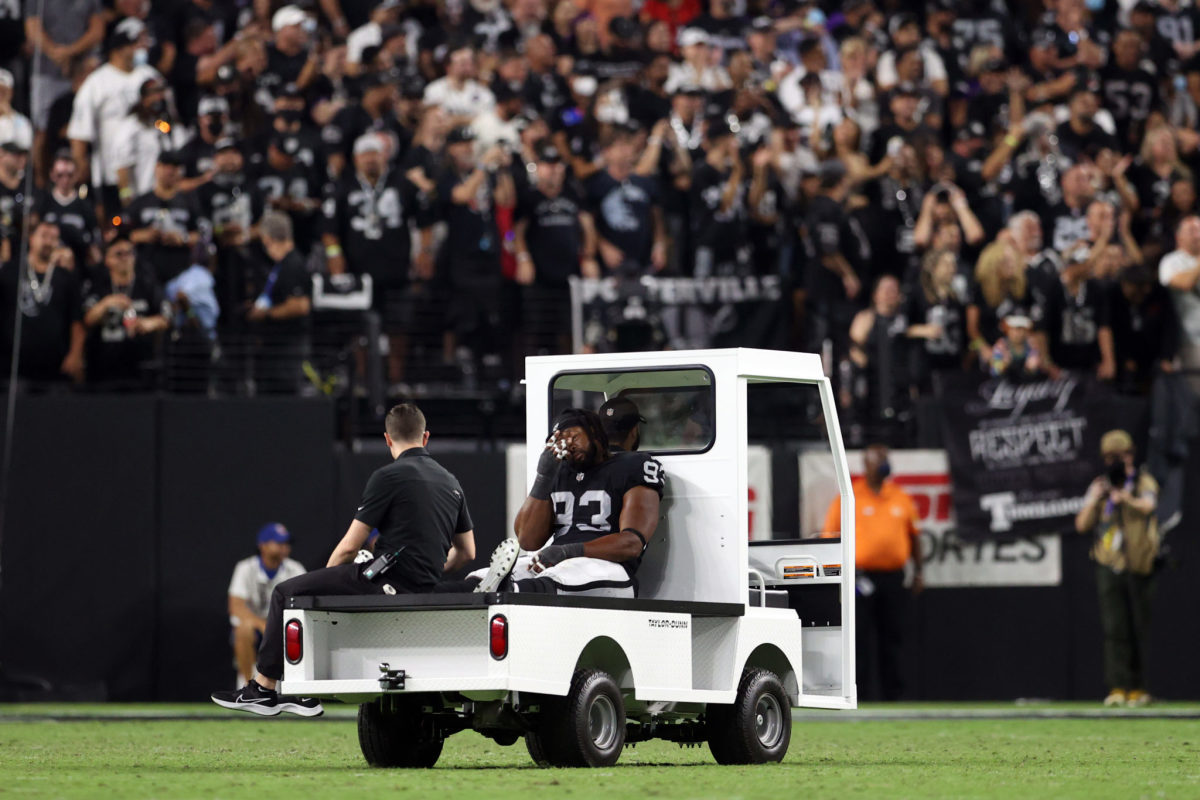 Gerald McCoy is carted off the field during a Raiders game.