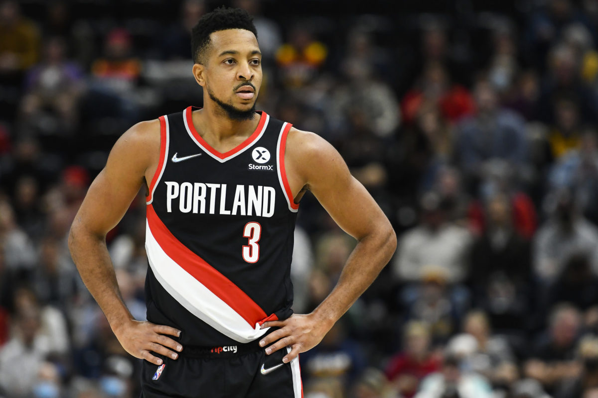 CJ McCollum stands with his hands on his hips.