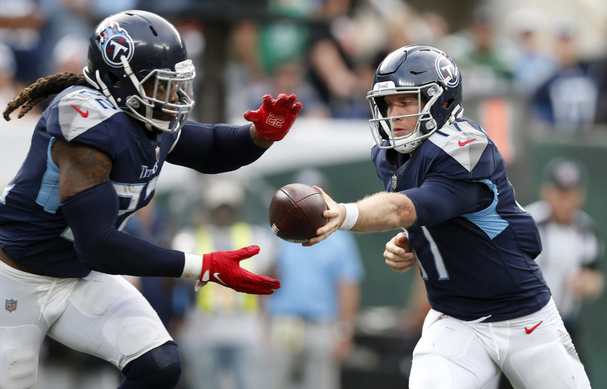 Tennessee Titans quarterback Ryan Tannehill hands the ball off to Derrick Henry.