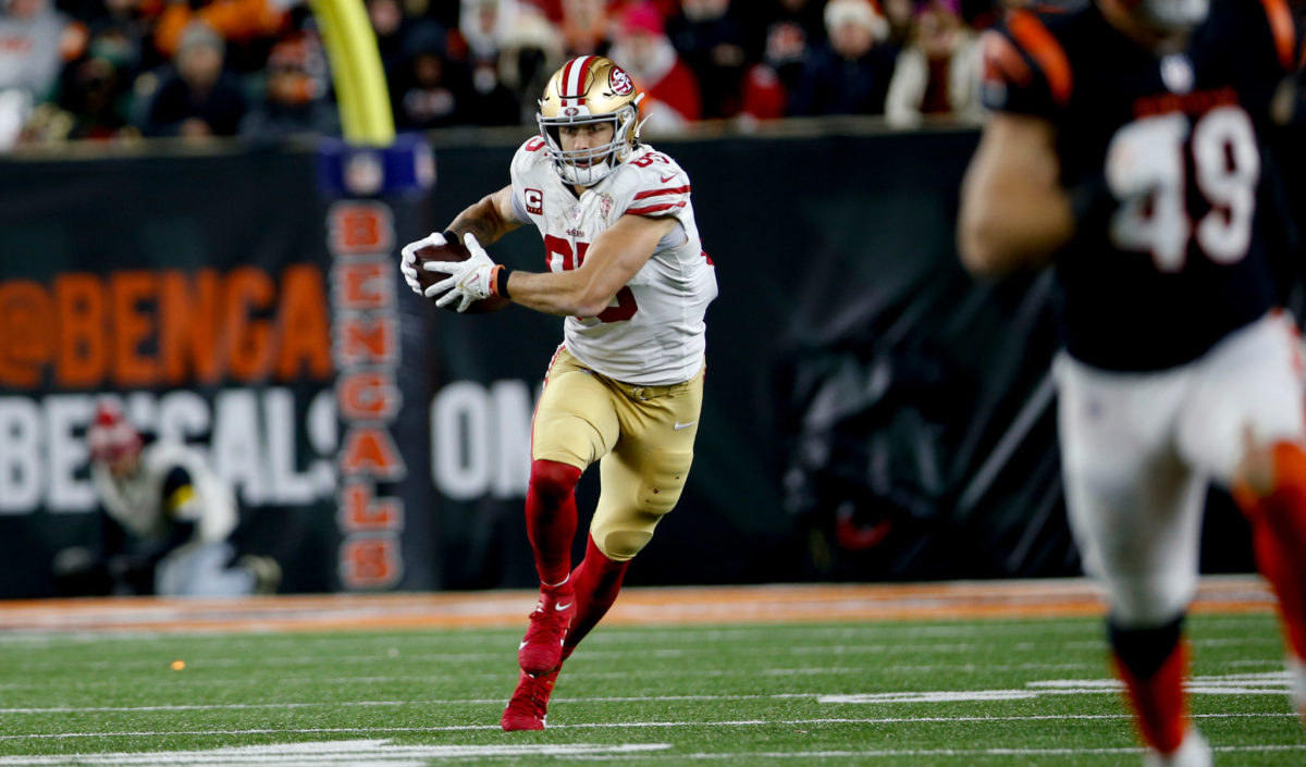 George Kittle runs with the ball.