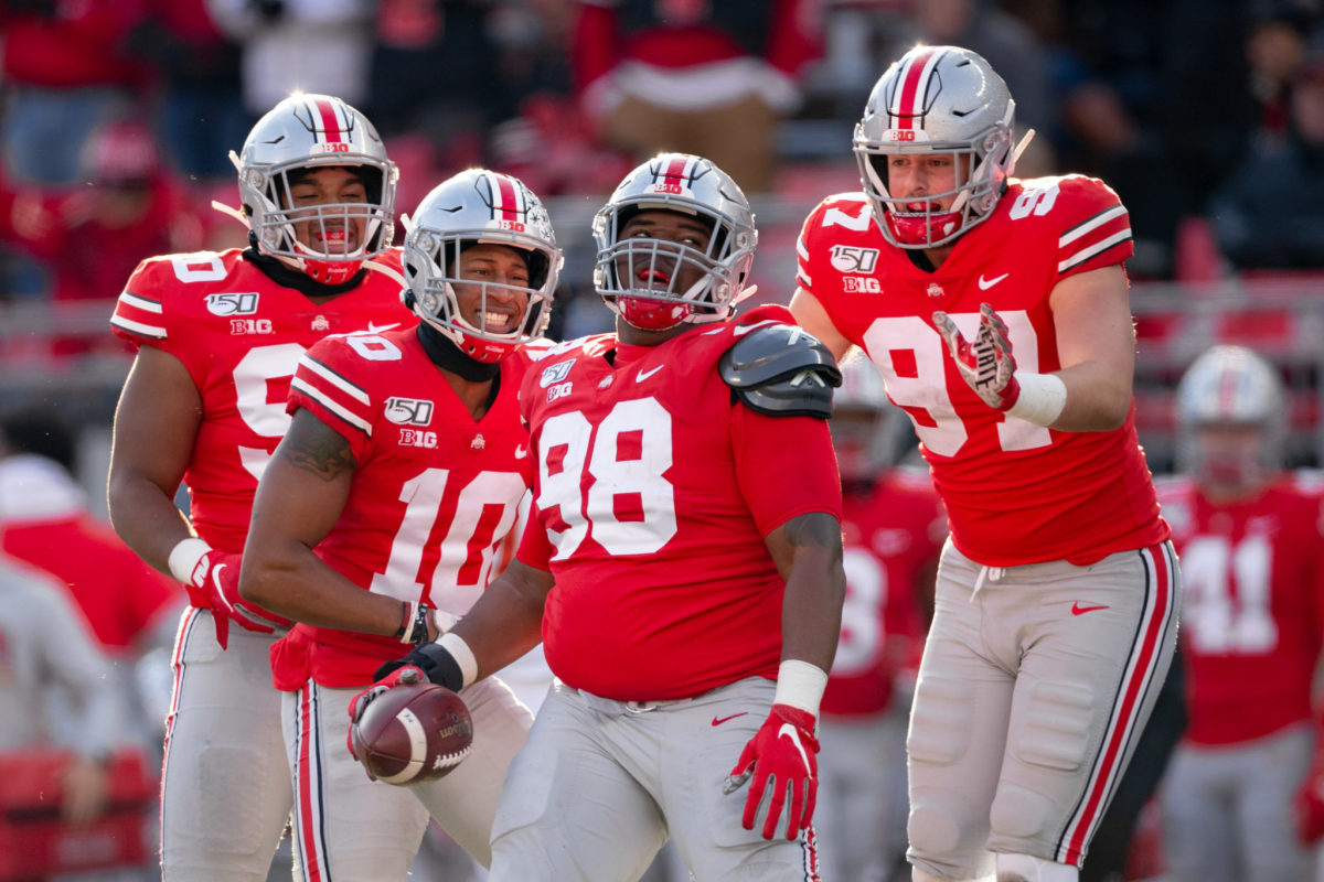 Ohio State defensive linemen celebrate a play during a college football game during the 2021 season.