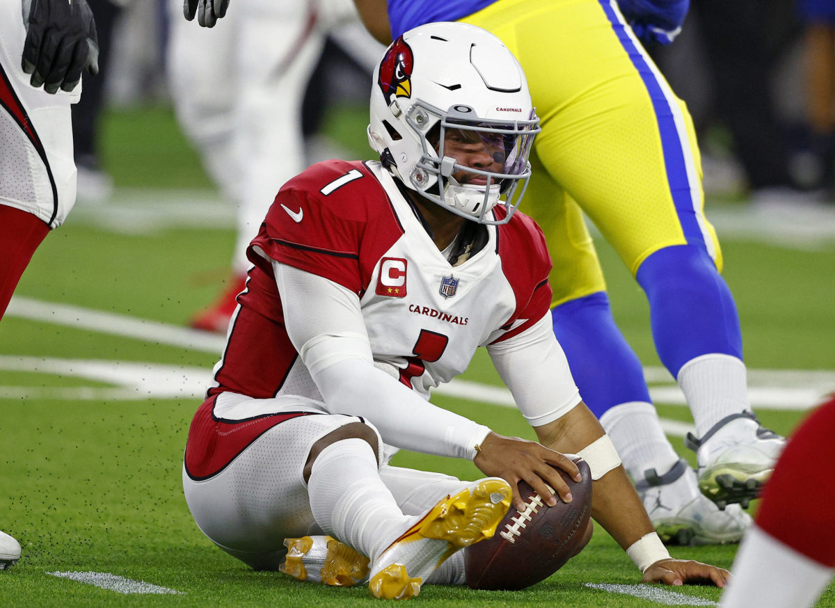 Cardinals quarterback Kyler Murray sitting on the ground after getting sacked.