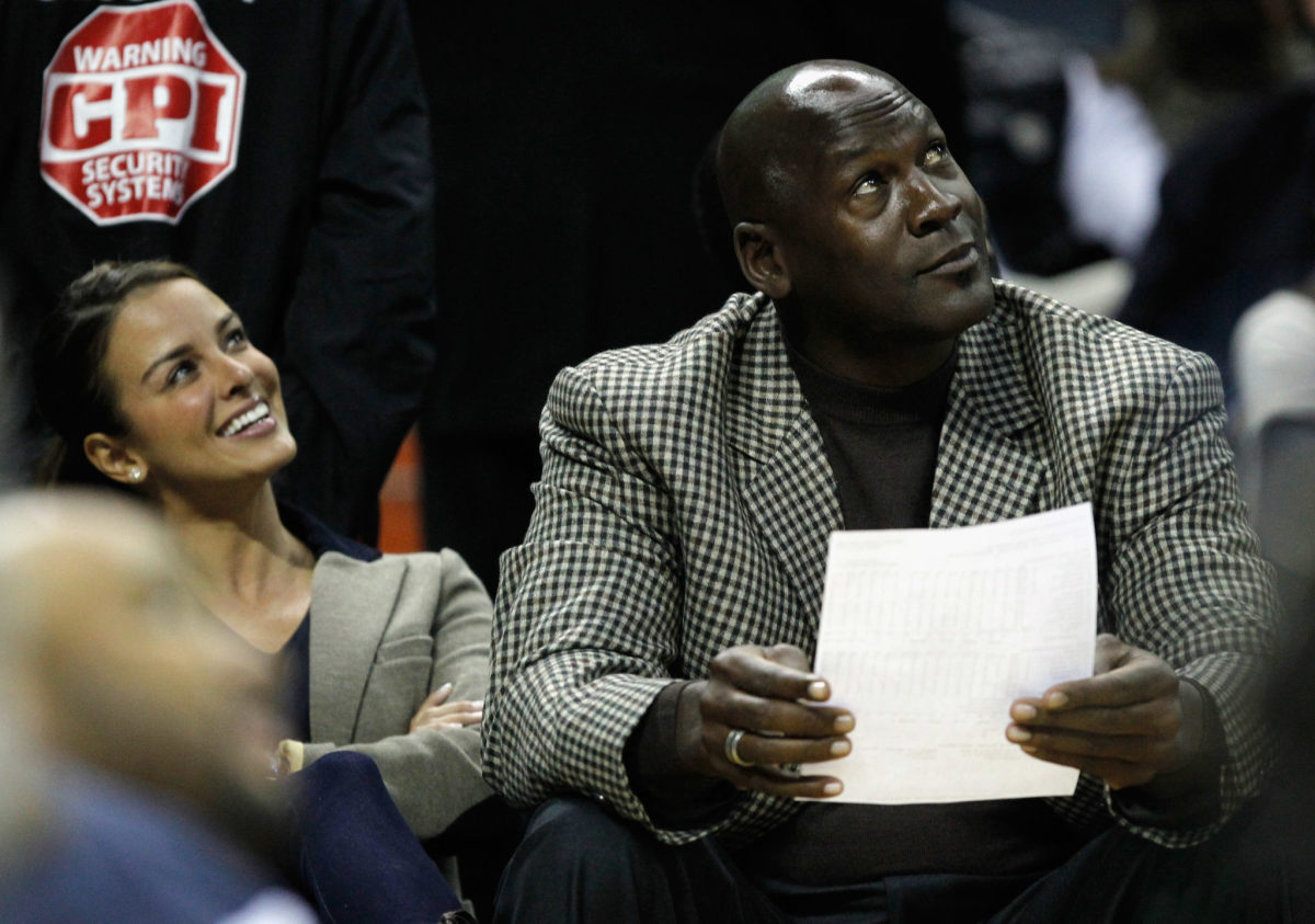 Michael Jordan attending an NBA game with his wife.