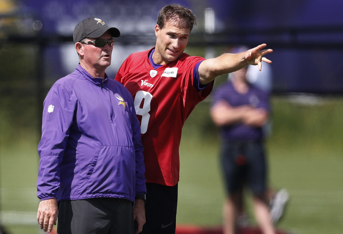 Minnesota Vikings head coach Mike Zimmer left and quarterback Kirk Cousins (8) went over a play during Minnesota Vikings training camp at TCO Performance center Saturday July 28, 2018 in Eagan, MN.