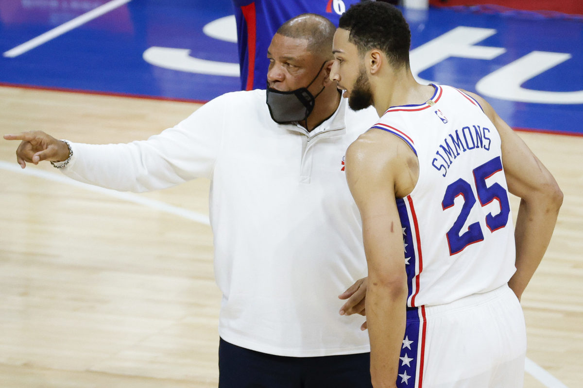 Doc Rivers speaks with Ben Simmons during a timeout.