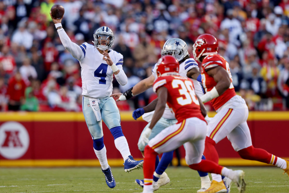 Cowboys quarterback Dak Prescott throws a pass with the Chiefs defense bearing down on him.