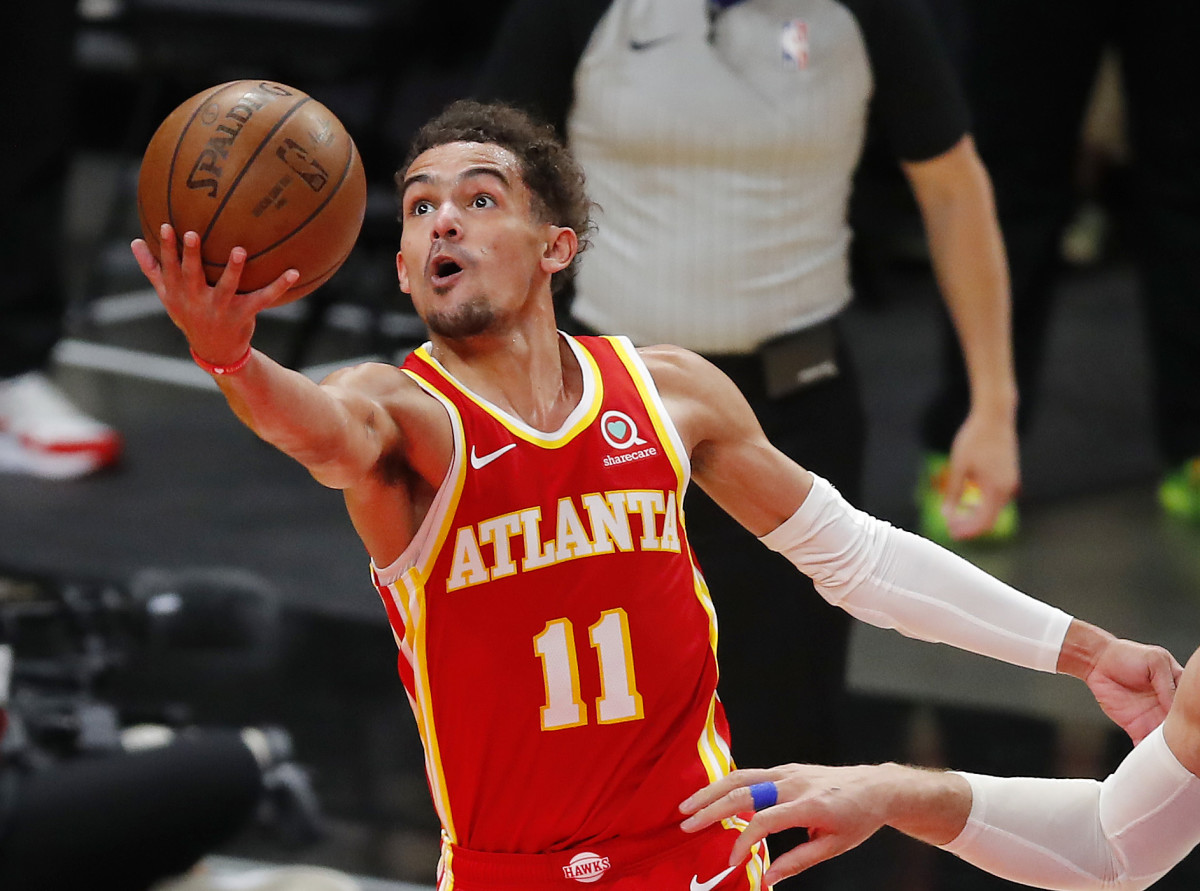 Hawks point guard Trae Young goes up for a finger roll layup.