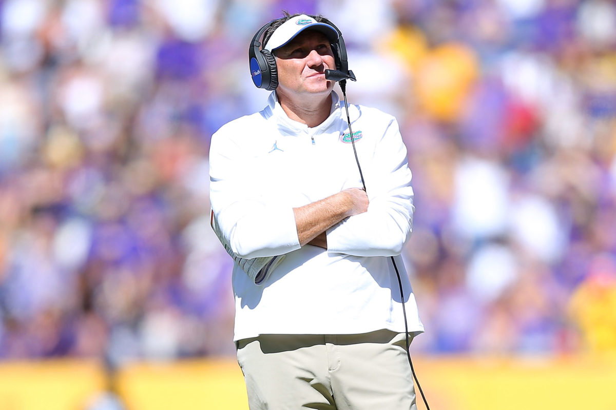 Florida head coach Dan Mullen stands on the sidelines with his arms crossed.